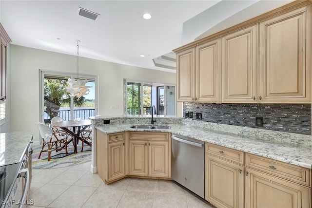 kitchen with light tile patterned flooring, decorative light fixtures, dishwasher, sink, and decorative backsplash