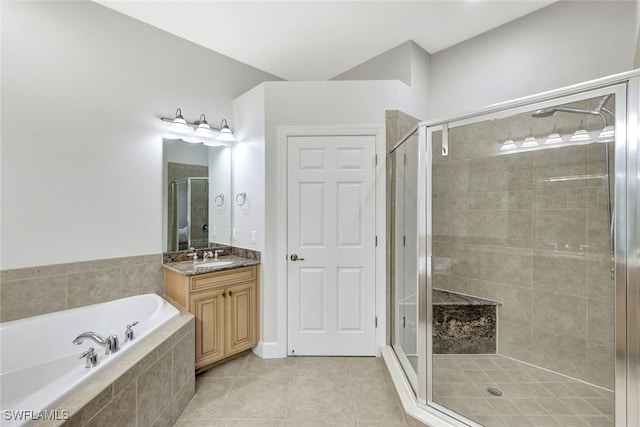 bathroom with a garden tub, a shower stall, vanity, and tile patterned floors