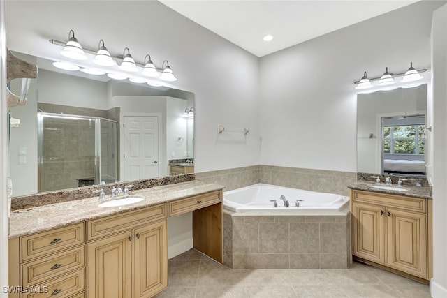 bathroom featuring tile patterned flooring, vanity, and independent shower and bath