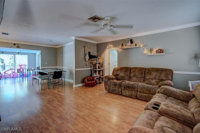 living room featuring crown molding, ceiling fan, hardwood / wood-style floors, and a textured ceiling