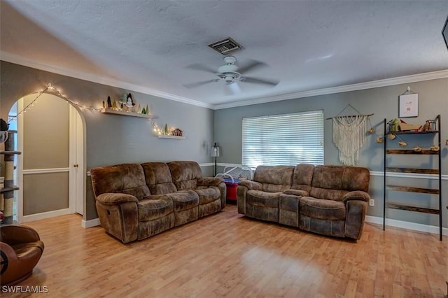 living room with crown molding, ceiling fan, light hardwood / wood-style floors, and a textured ceiling