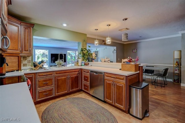 kitchen featuring pendant lighting, sink, stainless steel dishwasher, and kitchen peninsula