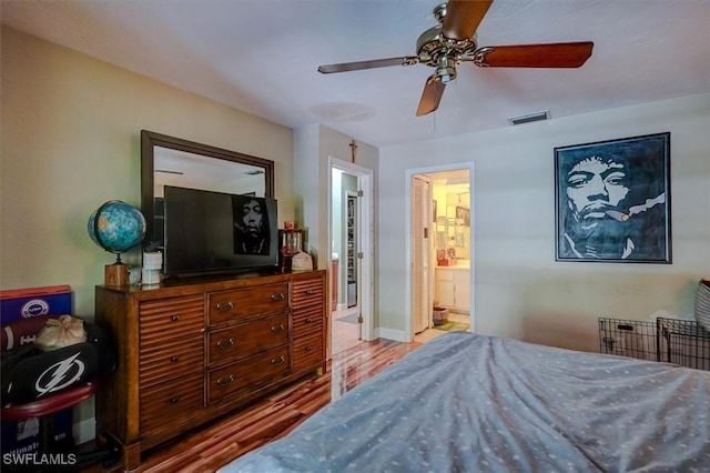 bedroom featuring ensuite bath, light hardwood / wood-style floors, and ceiling fan