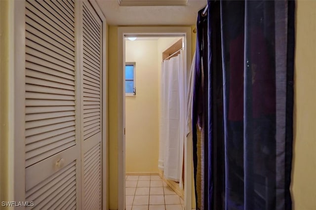 hall featuring light tile patterned flooring