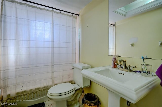 full bathroom featuring shower / bath combination with curtain, toilet, and sink