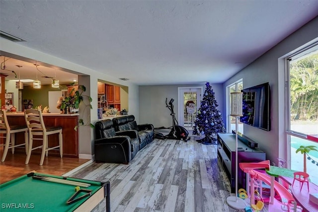 game room with light hardwood / wood-style flooring and billiards