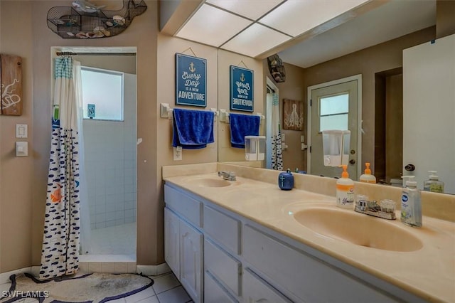 bathroom with tile patterned floors, vanity, and curtained shower