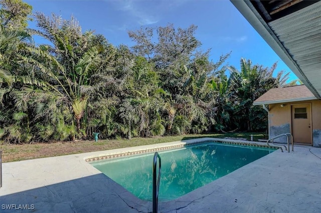 view of swimming pool with a patio area