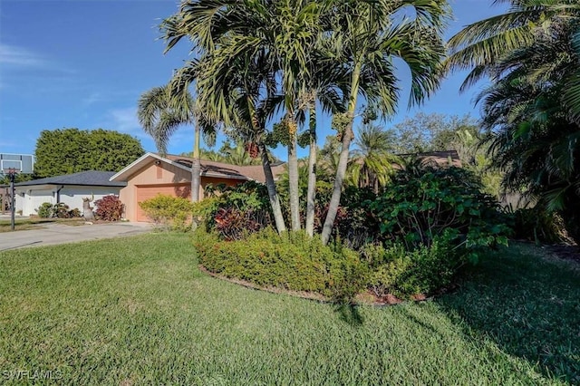 view of front of house with a garage and a front lawn