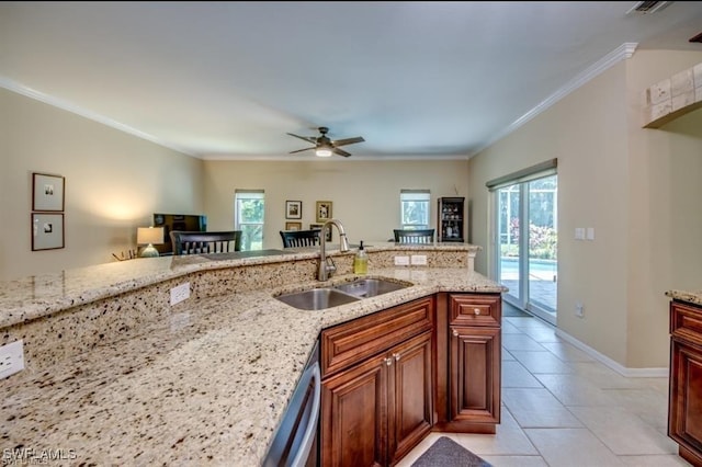 kitchen featuring sink, stainless steel dishwasher, light tile patterned floors, light stone counters, and crown molding