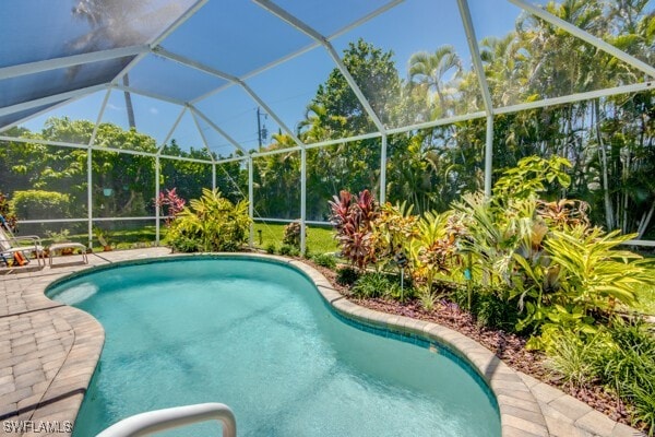 view of pool with a lanai and a patio