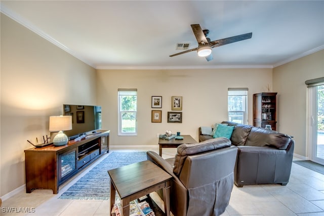 living room featuring light tile patterned floors, ornamental molding, and ceiling fan