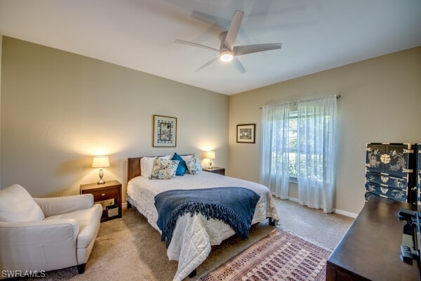 bedroom featuring light colored carpet and ceiling fan