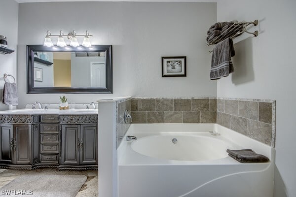 bathroom with vanity and a bath