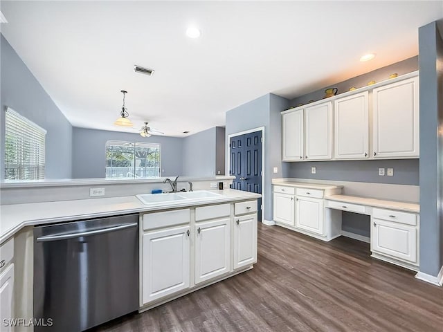 kitchen featuring built in desk, sink, white cabinets, hanging light fixtures, and stainless steel dishwasher