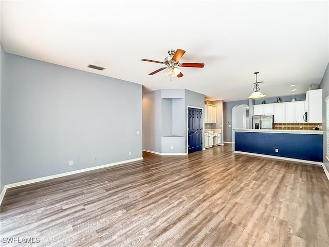 unfurnished living room with light hardwood / wood-style floors and ceiling fan