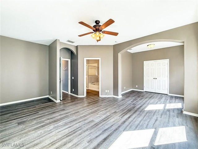 spare room with hardwood / wood-style flooring and ceiling fan