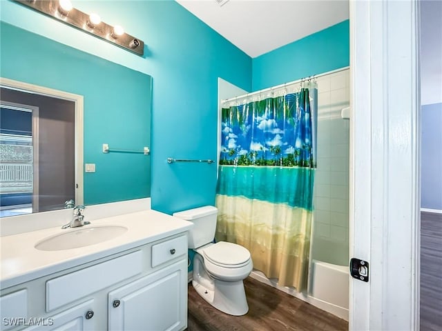 full bathroom featuring wood-type flooring, vanity, shower / bath combination with curtain, and toilet