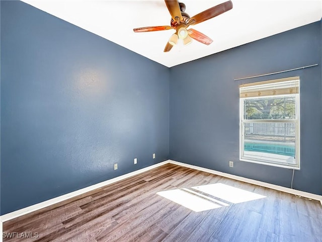 unfurnished room with hardwood / wood-style flooring and ceiling fan