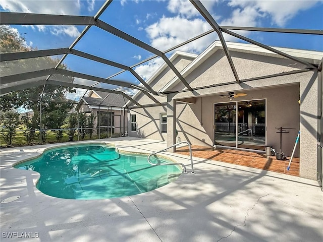 view of pool featuring a lanai, a patio, and ceiling fan