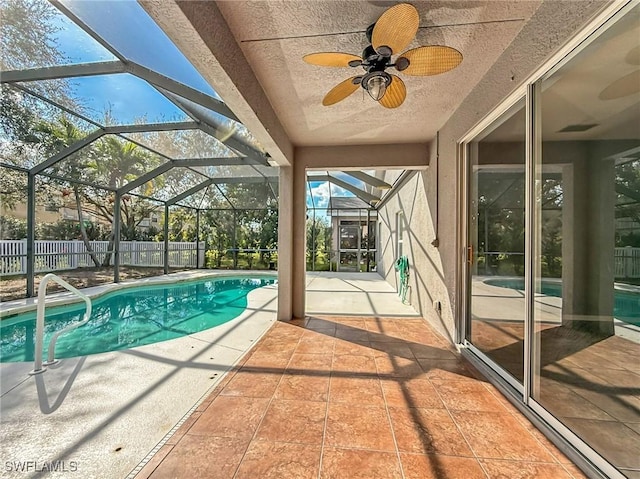 view of swimming pool featuring a patio, a lanai, and ceiling fan