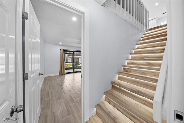 staircase with wood-type flooring