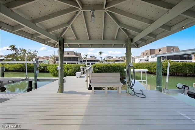 view of dock featuring a gazebo and a water view