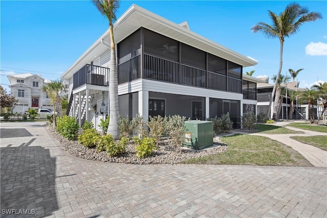 view of property exterior featuring a sunroom