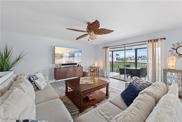 living room featuring ceiling fan and light wood-type flooring