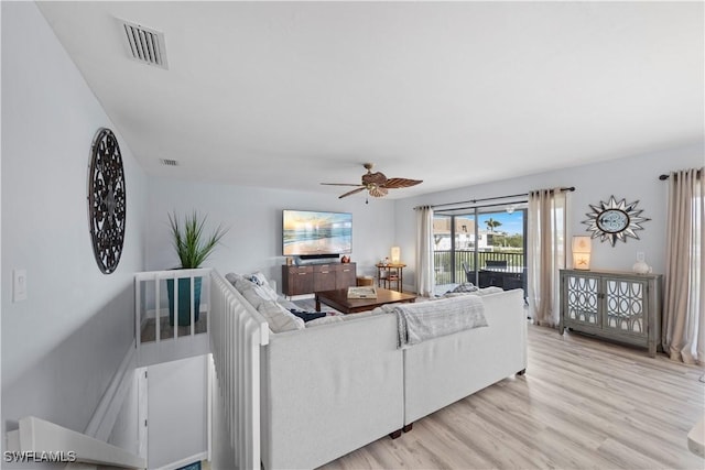 living room with ceiling fan and light wood-type flooring