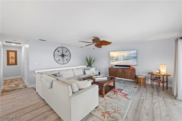 living room featuring ceiling fan and light wood-type flooring