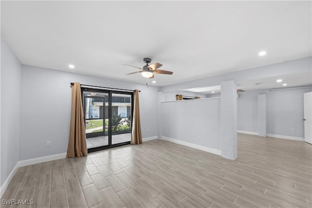 empty room with ceiling fan and light wood-type flooring