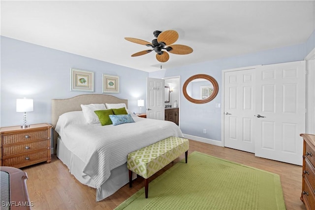 bedroom featuring ceiling fan, connected bathroom, and light wood-type flooring