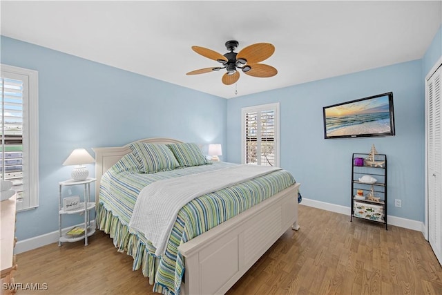 bedroom with a closet, ceiling fan, and light wood-type flooring