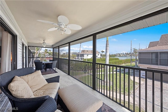 sunroom / solarium with a water view