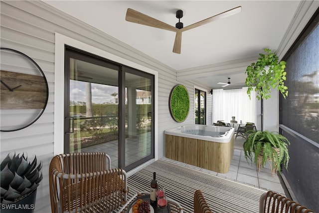 sunroom featuring a hot tub, ceiling fan, and a patio area