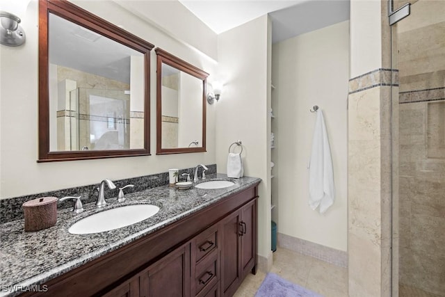 bathroom featuring vanity, a shower with shower door, and tile patterned floors