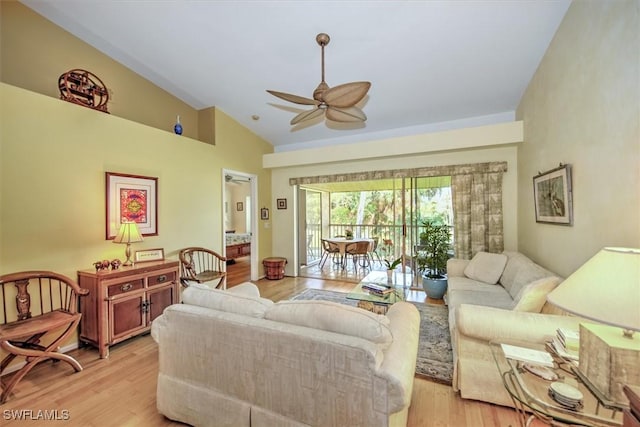 living room with ceiling fan, lofted ceiling, and light hardwood / wood-style flooring