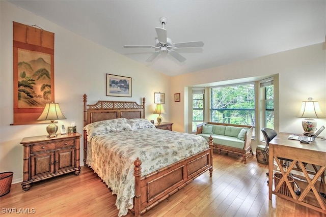 bedroom with light hardwood / wood-style flooring, ceiling fan, and vaulted ceiling