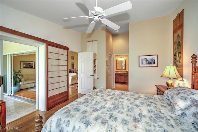 bedroom with sink, light hardwood / wood-style floors, ceiling fan, and ensuite bathroom