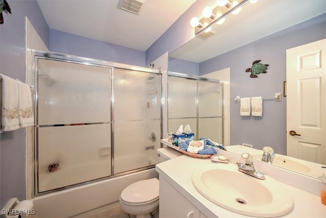 full bathroom featuring toilet, vanity, and bath / shower combo with glass door