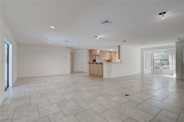 unfurnished living room featuring light tile patterned flooring