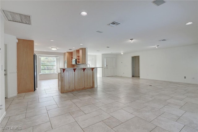 kitchen featuring kitchen peninsula and light tile patterned floors