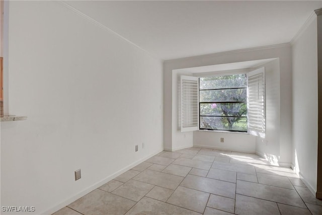 tiled spare room with crown molding