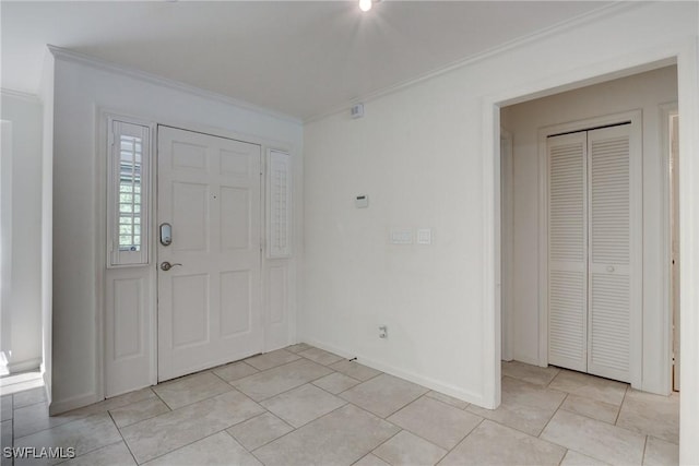 tiled foyer entrance featuring crown molding