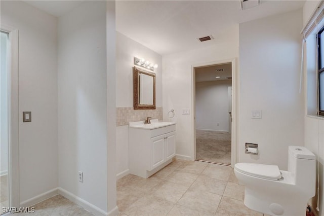 bathroom featuring vanity, tile patterned floors, and toilet