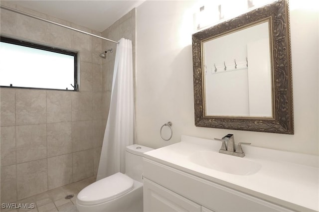 bathroom featuring vanity, toilet, and curtained shower