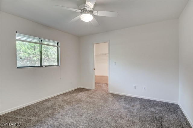 spare room with ceiling fan and carpet flooring