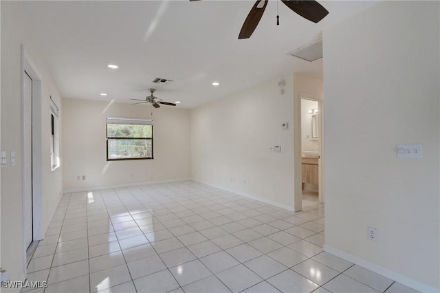 empty room with ceiling fan and light tile patterned floors