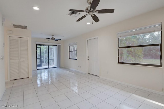 unfurnished room featuring light tile patterned floors and ceiling fan